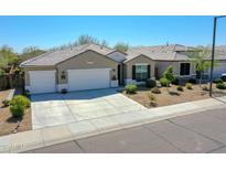 Charming single-story home with a well-maintained front yard and a spacious three-car garage at 13451 W Remuda Dr, Peoria, AZ 85383