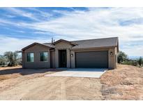 Charming single-story home featuring desert landscaping and a convenient two-car garage at 15519 E Windstone Trl, Rio Verde, AZ 85263