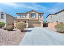 Charming two-story home featuring a well-maintained front yard and a spacious two-car garage at 21354 N Denver Ct, Maricopa, AZ 85138