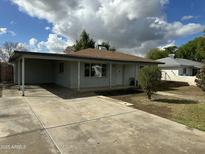 Charming single-story home featuring a covered carport and a spacious driveway at 3307 E Yale St, Phoenix, AZ 85008