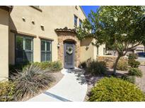 Charming home entrance with stone archway, a decorative wreath, and well-maintained landscaping at 4777 S Fulton Ranch Blvd # 1103, Chandler, AZ 85248