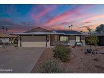 Charming single-Gathering home featuring a well-manicured lawn, desert landscaping and solar panels on roof at 516 E Gemini Dr, Tempe, AZ 85283