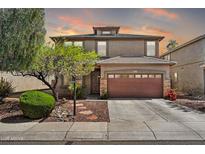 Charming two-story home showcasing a landscaped front yard and a two car garage at 6523 S 34Th Dr, Phoenix, AZ 85041