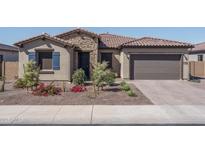 Charming single-story home featuring a stone facade, tile roof, and well-maintained landscaping in a desirable neighborhood at 7250 N 80Th Ln, Glendale, AZ 85303