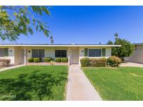 Charming single-story home with a well-manicured lawn and inviting curb appeal at 9231 N 111Th Ave, Sun City, AZ 85351