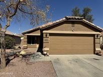 Charming single-story home with a well-maintained front yard and a two-car garage at 12046 W Scotts Dr, El Mirage, AZ 85335