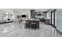 Open-concept kitchen with a center island, seating, and sleek gray cabinetry at 2818 E Malapai Dr, Phoenix, AZ 85028