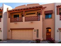 Inviting two-story townhome with a private balcony, garage, and charming desert landscaping at 333 N Pennington Dr # 63, Chandler, AZ 85224
