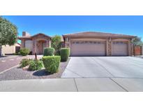 Charming single-story home with a three-car garage, stone accents and desert landscaping at 3818 N Kalispell Ct, Casa Grande, AZ 85122