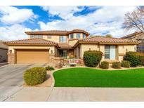 Charming two-story home featuring desert landscaping, a two-car garage, and a warm, inviting entryway at 4297 E Pyrenees Ct, Gilbert, AZ 85298