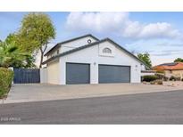 Charming home featuring a white stucco exterior and a spacious two-car gray garage at 5742 W Shannon St, Chandler, AZ 85226