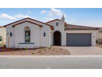 Charming single-story home with a tile roof, arched entry and low maintenance desert landscaping at 5779 N 207Th Ave, Buckeye, AZ 85396