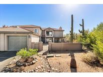 Inviting two-story home featuring a charming gated courtyard and desert landscaping at 7220 E Mary Sharon Dr # 116, Scottsdale, AZ 85266