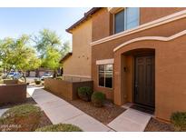 Inviting front entrance with a well-lit walkway leading to the stylish front door at 7726 E Baseline Rd # 134, Mesa, AZ 85209