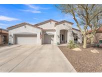 Charming single-story home featuring a stucco exterior, three-car garage and desert landscaping at 9626 W Bajada Rd, Peoria, AZ 85383