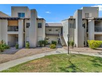 Beautiful two-story condo complex with well-maintained landscaping and inviting walkways at 14145 N 92Nd St # 2046, Scottsdale, AZ 85260