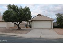 Charming single-story home featuring a well-manicured front yard and a two-car garage at 1620 E Jacinto Ave, Mesa, AZ 85204