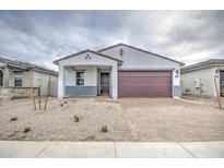 Home with modern design, a brick driveway, and desert landscaping at 17567 W Adams St, Goodyear, AZ 85338