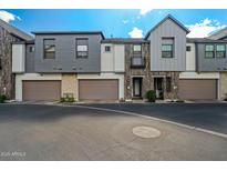 Charming townhomes showcasing a blend of modern design with gray siding and private garages at 3200 N 39Th St # 4, Phoenix, AZ 85018
