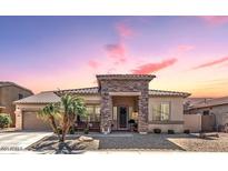 Charming single-story home features a stone facade, desert landscaping, and inviting entry way at 3285 E Phelps St, Gilbert, AZ 85295