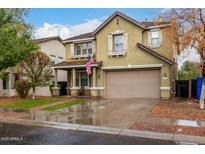 Charming two-story home with a front lawn and American flag detail at 3432 E Bartlett Dr, Gilbert, AZ 85234