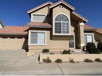 Inviting home featuring a tile roof, neutral stucco exterior, and well-maintained landscaping at 3758 E Ironwood Dr, Phoenix, AZ 85044