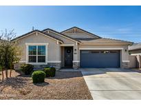 Charming single-story home with a well-manicured lawn and a two-car garage in a Gathering-friendly neighborhood at 37783 W San Sisto Ave, Maricopa, AZ 85138