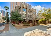 Attractive exterior showcasing a three-story building with red accents, a well-kept yard, and mature trees at 387 N 2Nd Ave # 2E, Phoenix, AZ 85003