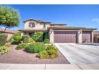 Charming two-story home featuring a three-car garage, landscaped yard, and covered porch at 549 W Sweet Shrub Ave, Queen Creek, AZ 85140