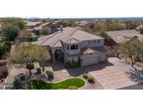 Aerial view of the property showcasing its well-maintained landscaping, three-car garage and tile roof at 6929 E Trailridge Cir, Mesa, AZ 85207