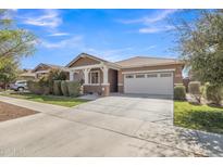 Charming one-story home featuring a two-car garage, covered entry, and well-maintained front yard at 7115 E Olla Ave, Mesa, AZ 85212