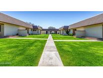 Apartment community with lush green lawns and walkways offering serene outdoor living at 8101 N 107Th Ave # 26, Peoria, AZ 85345