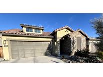 Charming single-story home featuring stone accents, a tile roof, and a well-manicured front yard with desert landscaping at 8842 S 165Th Ave, Goodyear, AZ 85338