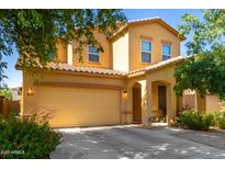 Inviting two-story home featuring a spacious two car garage and charming desert landscaping at 10037 W Watkins St, Tolleson, AZ 85353