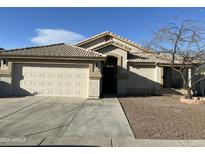 Charming single-story home featuring a two-car garage, low maintenance landscaping, and a neutral color palette at 1102 W Burgess Ln, Phoenix, AZ 85041