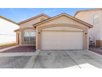 Charming single-story home featuring a two-car garage and low-maintenance desert landscaping at 11829 W Rosewood Dr, El Mirage, AZ 85335