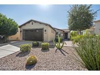 Charming single-story home featuring a low maintenance desert landscape and a large garage at 1357 E Elysian Pass, Queen Creek, AZ 85140