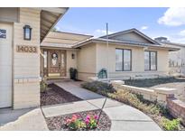 Charming single-story home with a brick facade, well-manicured landscaping, and a welcoming front porch entry at 14033 N 39Th Ln, Phoenix, AZ 85053