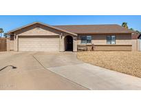 Charming single story home with a well manicured lawn, driveway, and two car garage at 1708 N Burbank Ct, Chandler, AZ 85225