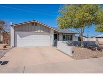 Charming single-story home featuring a two-car garage and well-maintained landscaping at 1830 N 87Th Way, Scottsdale, AZ 85257