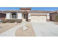 Beautiful single-story home showcasing a well-manicured yard and a two-car garage at 18430 E Azul Ct, Gold Canyon, AZ 85118