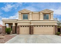 Two-story home featuring a three-car garage and desert landscaping at 2023 S 106Th Ave, Tolleson, AZ 85353