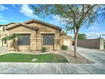 Charming single-story home with desert landscaping, a long driveway, and neutral colors at 2093 N Illinois St, Chandler, AZ 85225