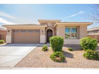 Charming single-story home with a stone facade, well-manicured landscaping, and a two-car garage at 21295 E Estrella Rd, Queen Creek, AZ 85142