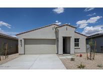 Single-story home showcasing a neutral color palette, xeriscaping, and a two-car garage under a bright blue sky at 2570 E Music Mountain Ave, Apache Junction, AZ 85119