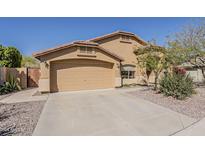 Single-Gathering home with a two-car garage, landscaped yard, and neutral color scheme, perfect for suburban living at 3116 W Folgers Rd, Phoenix, AZ 85027