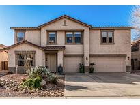 Charming two-story home featuring a three car garage and desert landscaping for easy maintenance at 3213 W Desert Vista Trl, Phoenix, AZ 85083