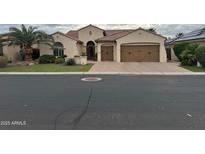 Charming single-story home featuring desert landscaping, a private courtyard, and a three-car garage at 3234 N 163Rd Dr, Goodyear, AZ 85395