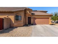 A charming single-Gathering home with a two-car garage, desert landscaping, and a tiled roof at 913 W Jessica Ln, Phoenix, AZ 85041