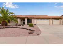 Inviting home featuring desert landscaping, a well-maintained lawn, and a multi-car garage at 9526 W Menadota Dr, Peoria, AZ 85382